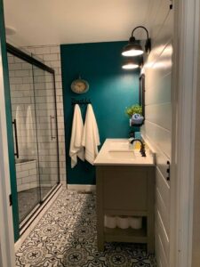 Unique green wall with bright white sink